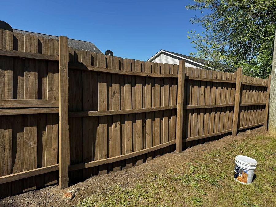 Board-on-board privacy fence stained on both faces in Upstate South Carolina