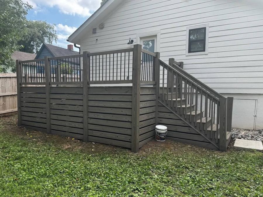 Grey stained deck, rails, and skirting on the side of a house