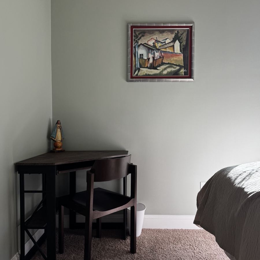 Interior room with a painted accent wall behind a dark wood corner desk and chair