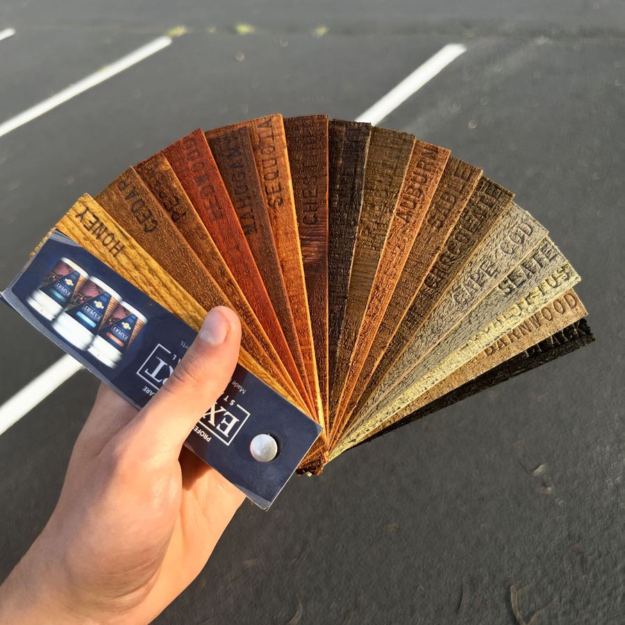 Stain color fan held over freshly stained wood boards